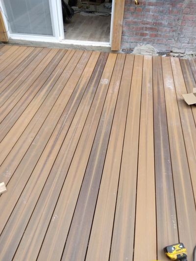 Composite deck boards beside a brick exterior wall